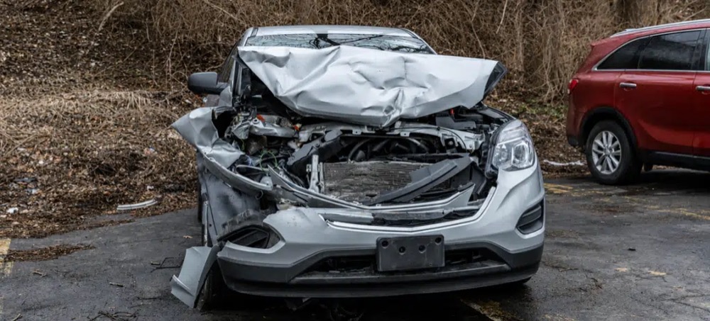 Silver SUV with severe front-end collision damage